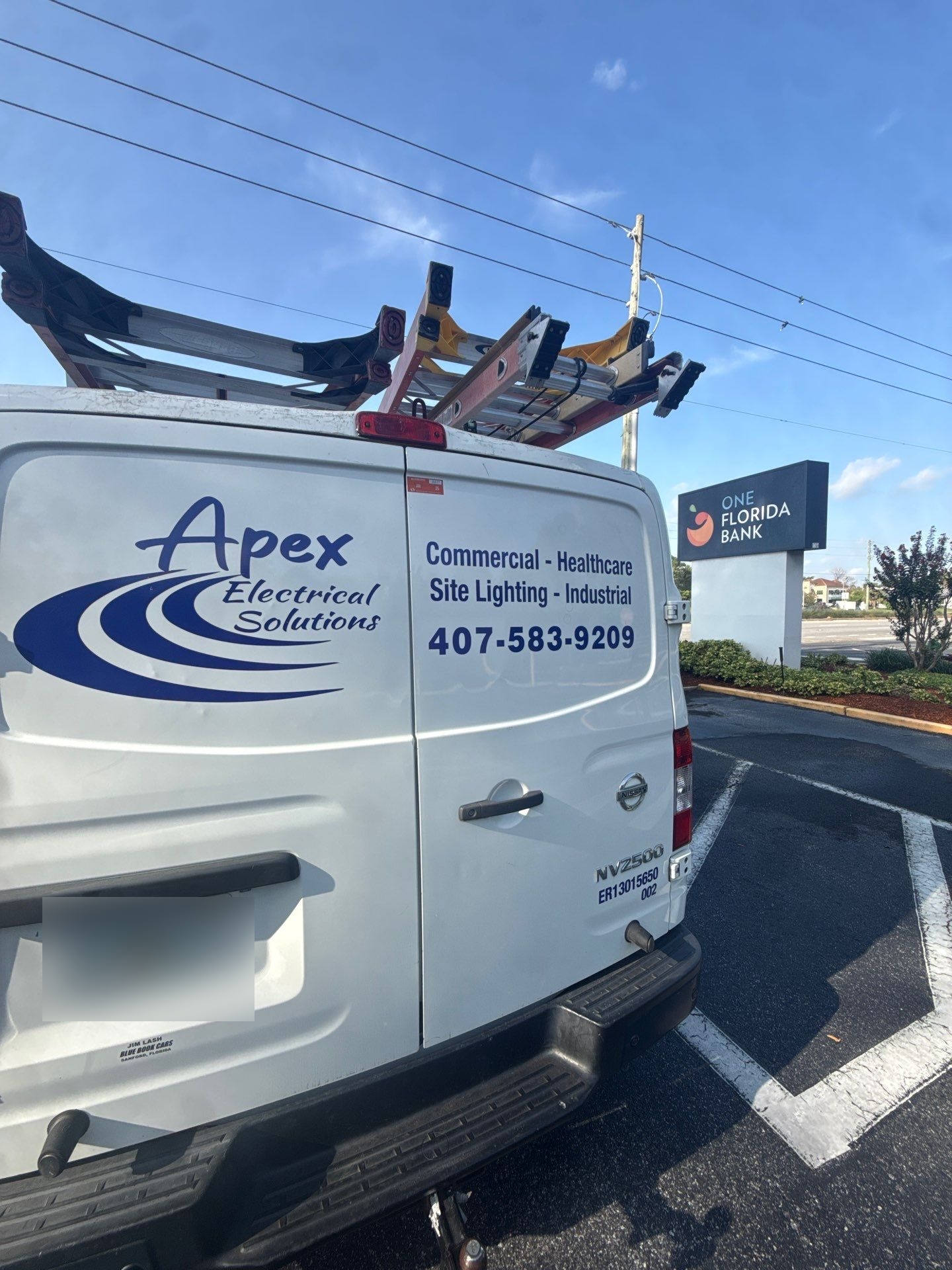 Apex Electrical Solutions vehicle parked next to a One Florida Bank sign